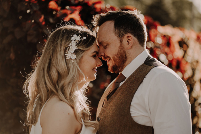 Bride and groom smile at each other during couple portraits