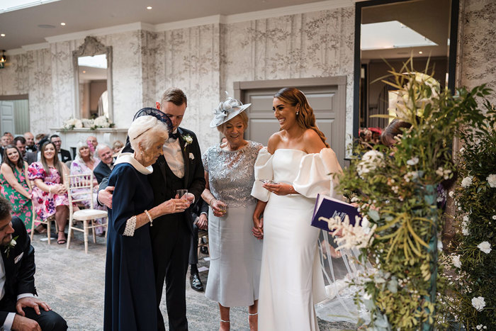 Bride and grooms grandmothers doing Quaich at the altar