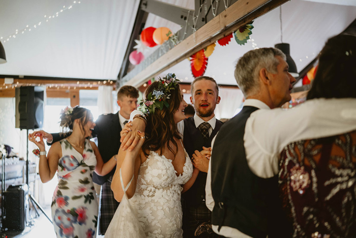 Bride and groom join guests on the floor for some ceilidh dancing