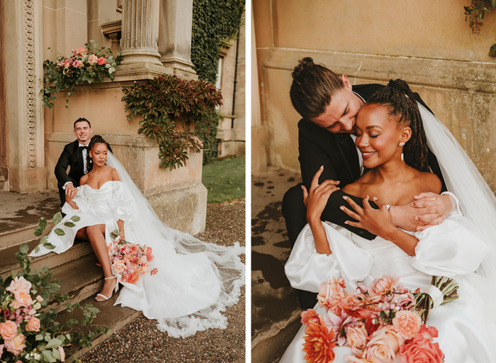 Bride and groom sit together on venue steps, bride's gown cascading down steps