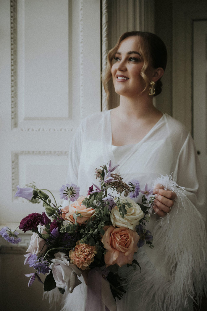 bride holding pastel coloured flowers Chatelherault shoot