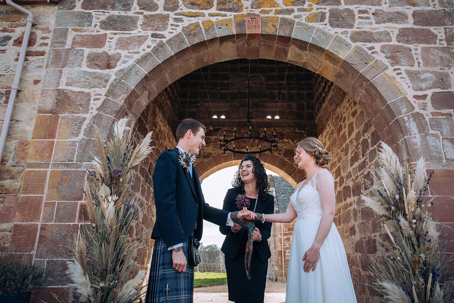 Bride and groom at the altar smiling