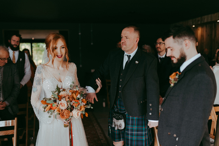 Bride's brother walks her down the aisle to meet groom