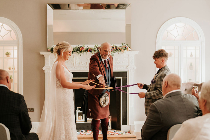 Brides do hand fasting ceremony during their wedding