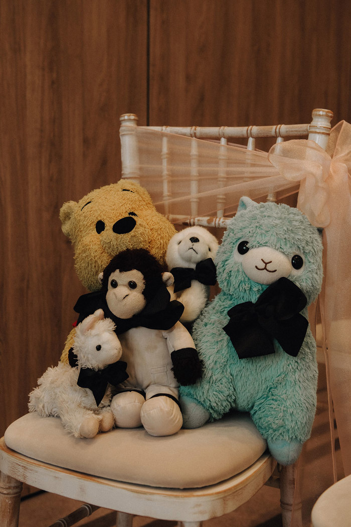 soft toys sitting on a chiavari chair