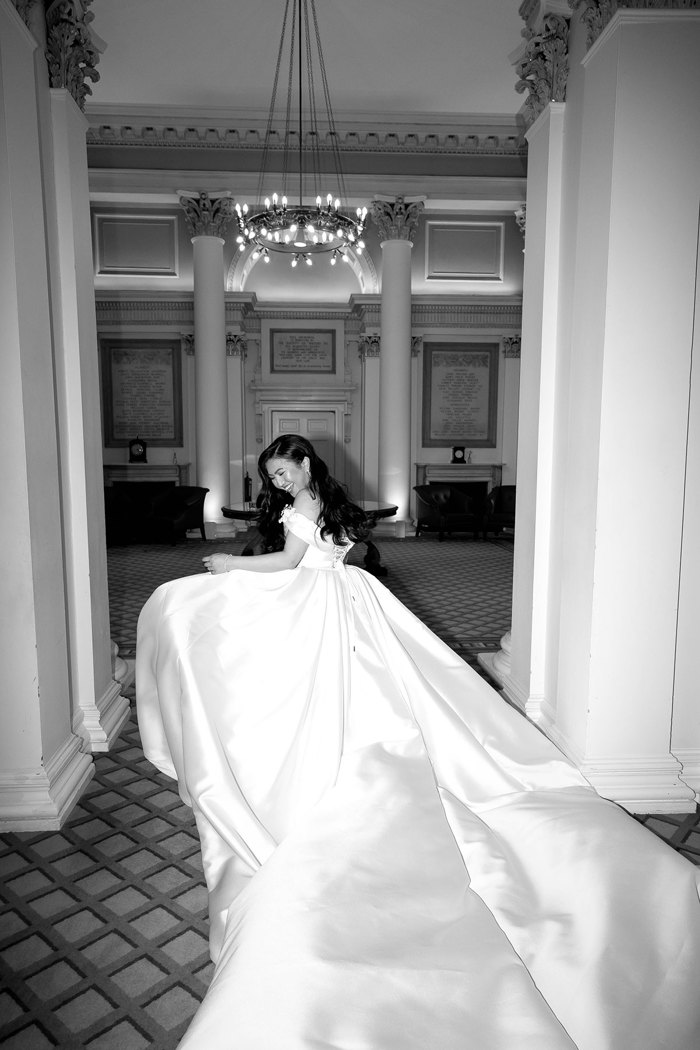 black and white photography of bride's wedding train at signet library edinburgh