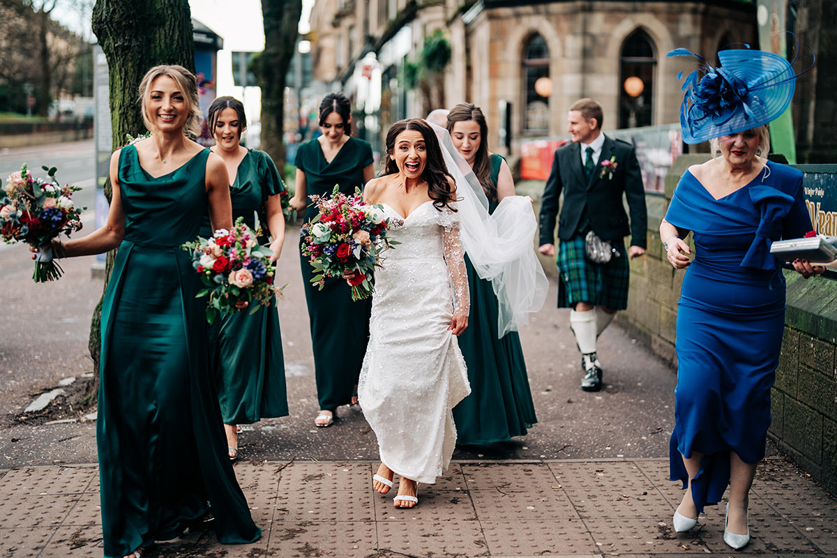 bride smiles as she arrives at oran mor with bridesmaids on wedding day