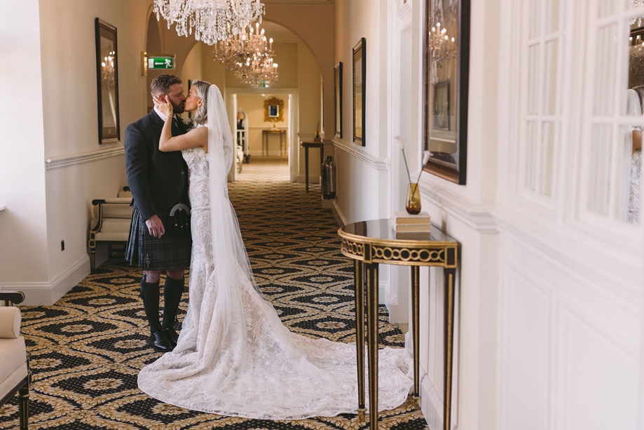 Bride and groom kiss during couple portrait in Trump Turnberry