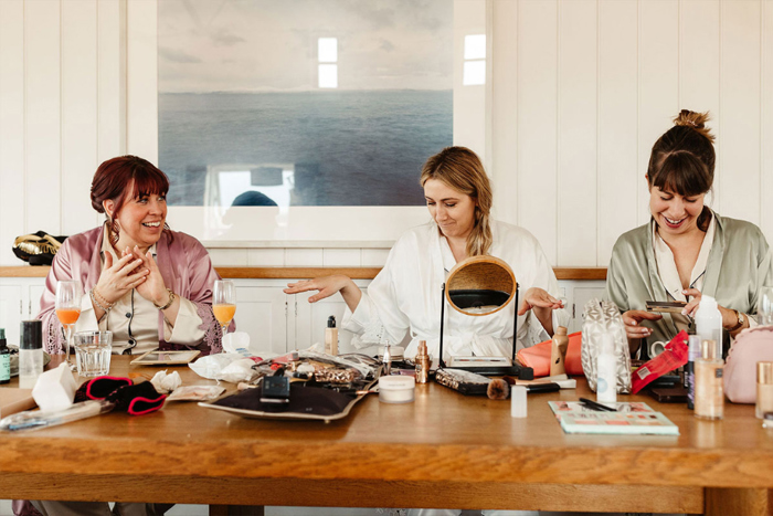 Bride and bridesmaids do their makeup on the wedding morning