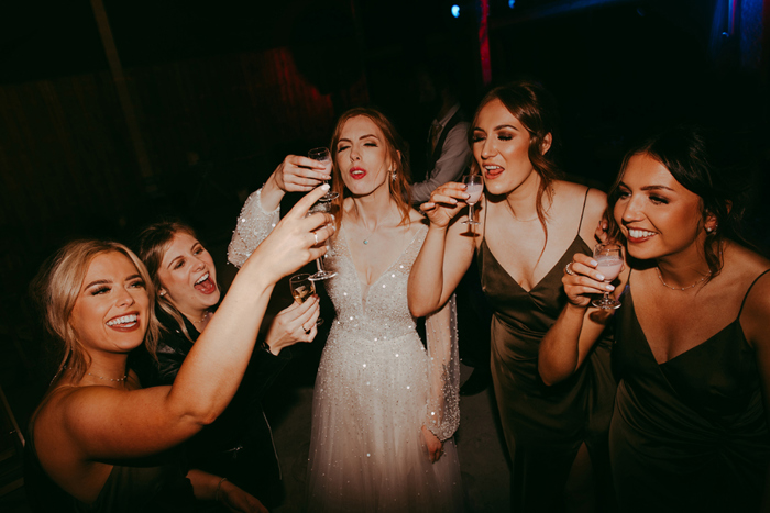 Bride and bridesmaids doing shots