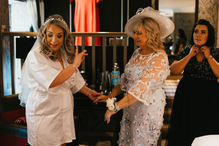 An Emotional Bride With A Lady In A Hat