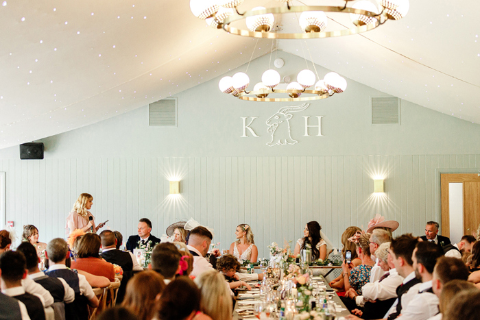 Top table look at bridesmaid giving a speech