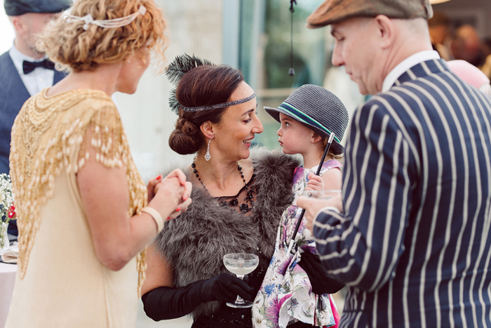 Bride wearing black dress mingling with guests