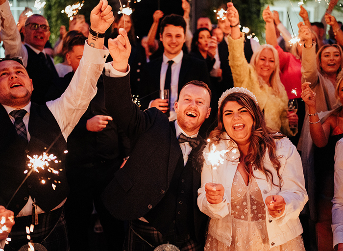 A group of people holding sparklers