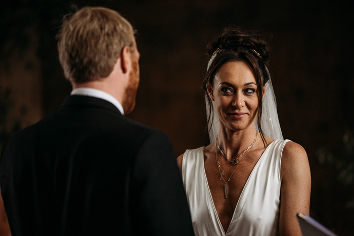 A Person Wearing A White V Neck Dress Looking At Another Person