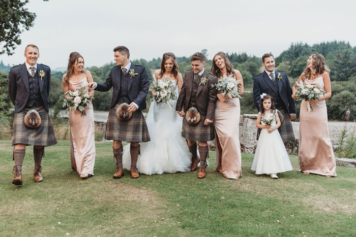 Group shot of bride, groom, bridesmaids, flower girl and groomsmen