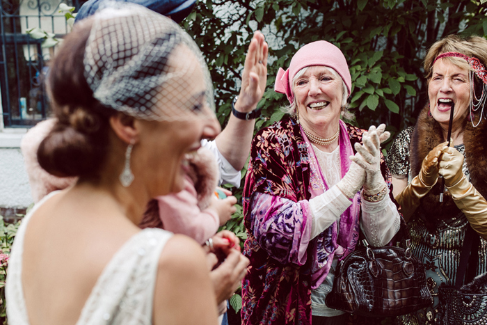 Guests cheering during wedding ceremony