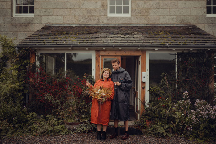 A person and person standing in front of a house at The Dell of Abernethy.