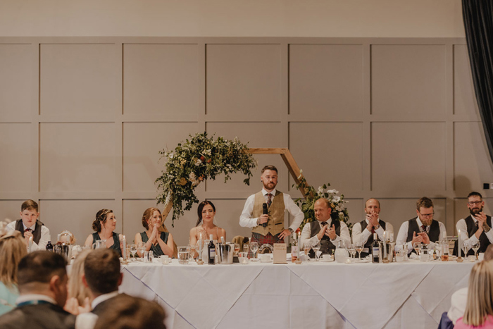 Groom stands up to deliver speech