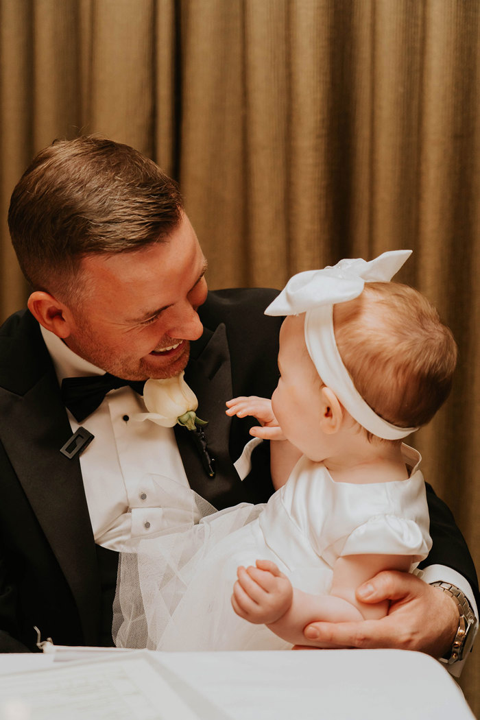 a person smiling at a baby.