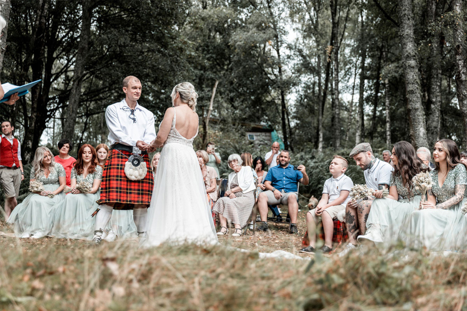 Couple hold hands during ceremony