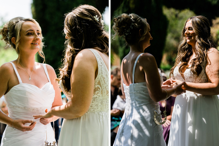 Brides put wedding rings on each other's fingers