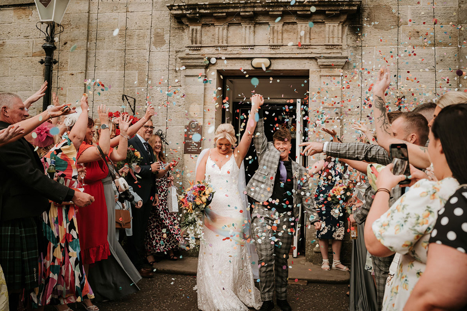 Couple emerge from venue to a confetti shower