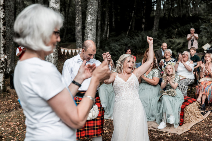 Bride cheers at wedding ceremony 