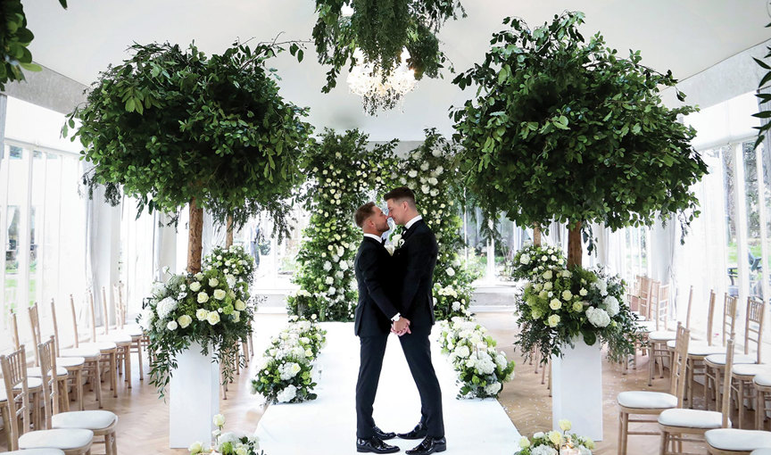 Two men kissing in a wedding ceremony