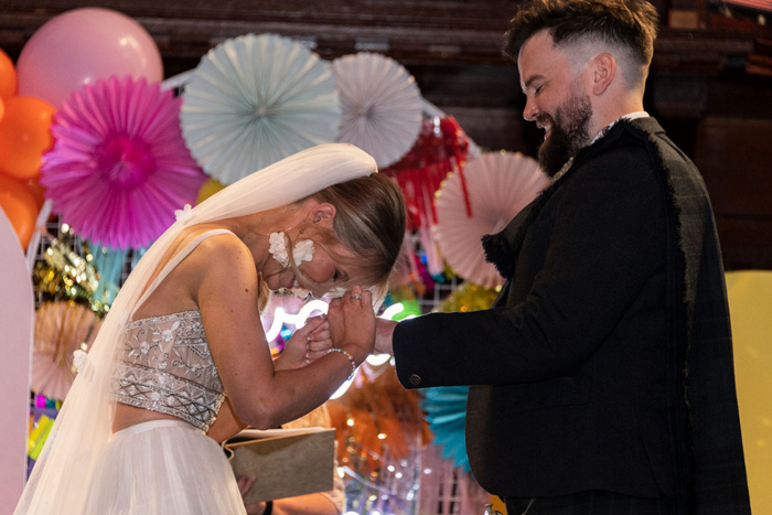 Bride and groom laugh during their wedding ceremony at St Luke's Glasgow