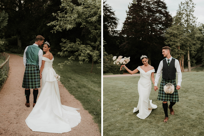 A bride and groom walking outside across a path and grass