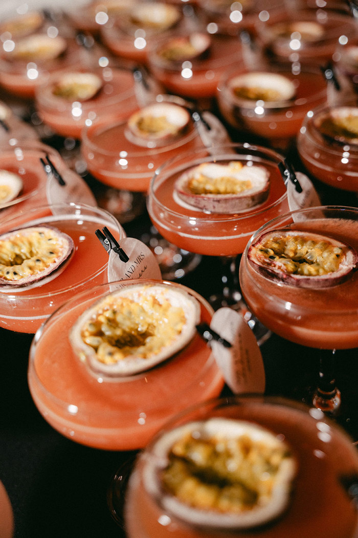 rows of the same red, passion-fruit based cocktail sit in line with the same little black clip and round paper card attached to the top