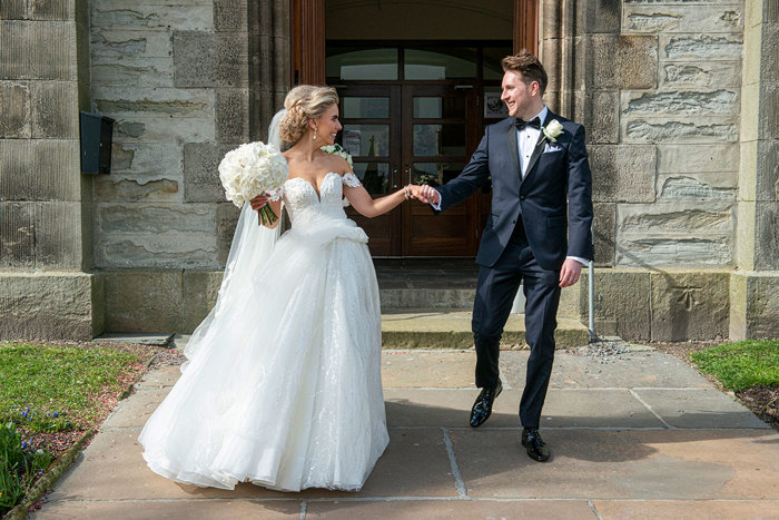 A Bride Wearing A Martina Liana Wedding Dress With A Groom Wearing A Black Dinner Suit Outside St Peters & St Andrews Church In Thurso