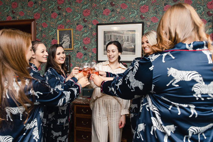 Bride and bridesmaid cheers before getting ready