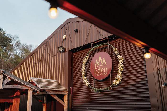 the outside sign of a barn titled Eden Leisure Village