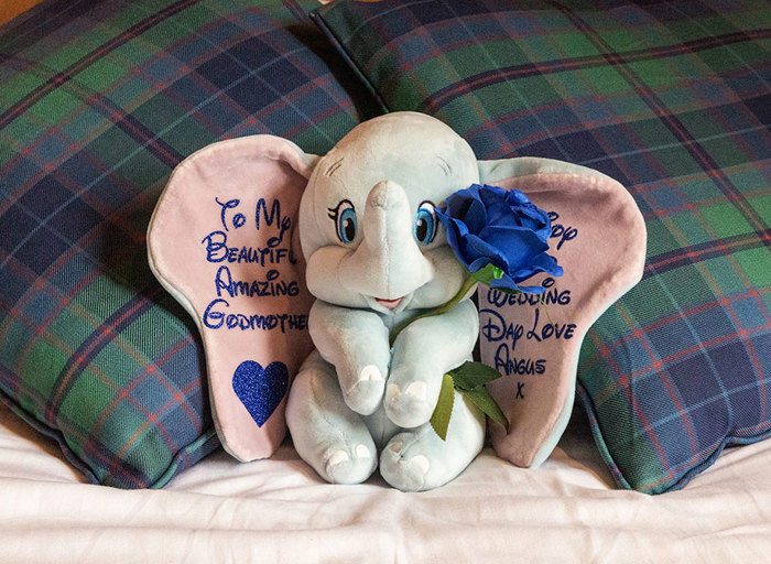 A toy of Dumbo the elephant with the words 'To my beautiful amazing godmother on your wedding day love Angus x' on the ears