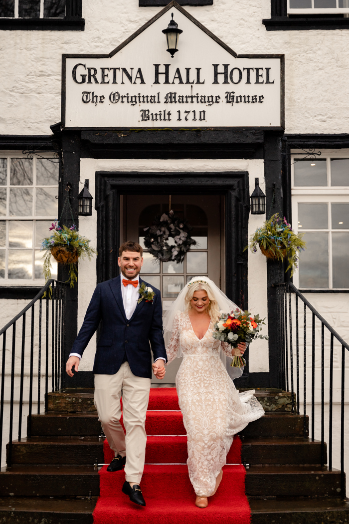 bride and groom leaving gretna green hotel after getting married