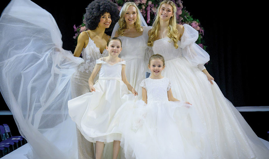 a group of women in ivory dresses on the catwalk at the Scottish Wedding Show