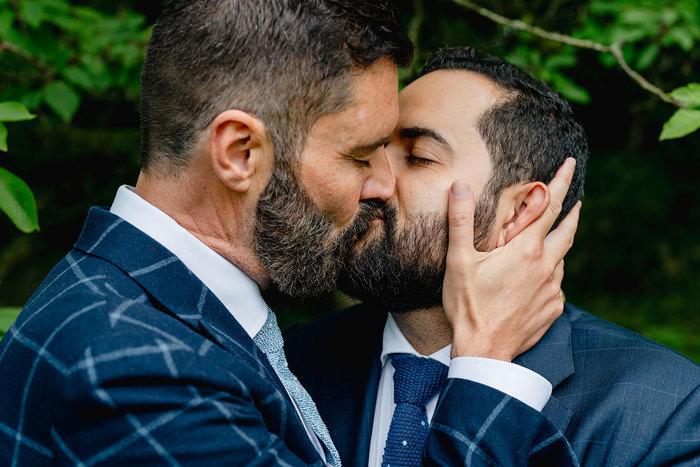 Grooms kissing