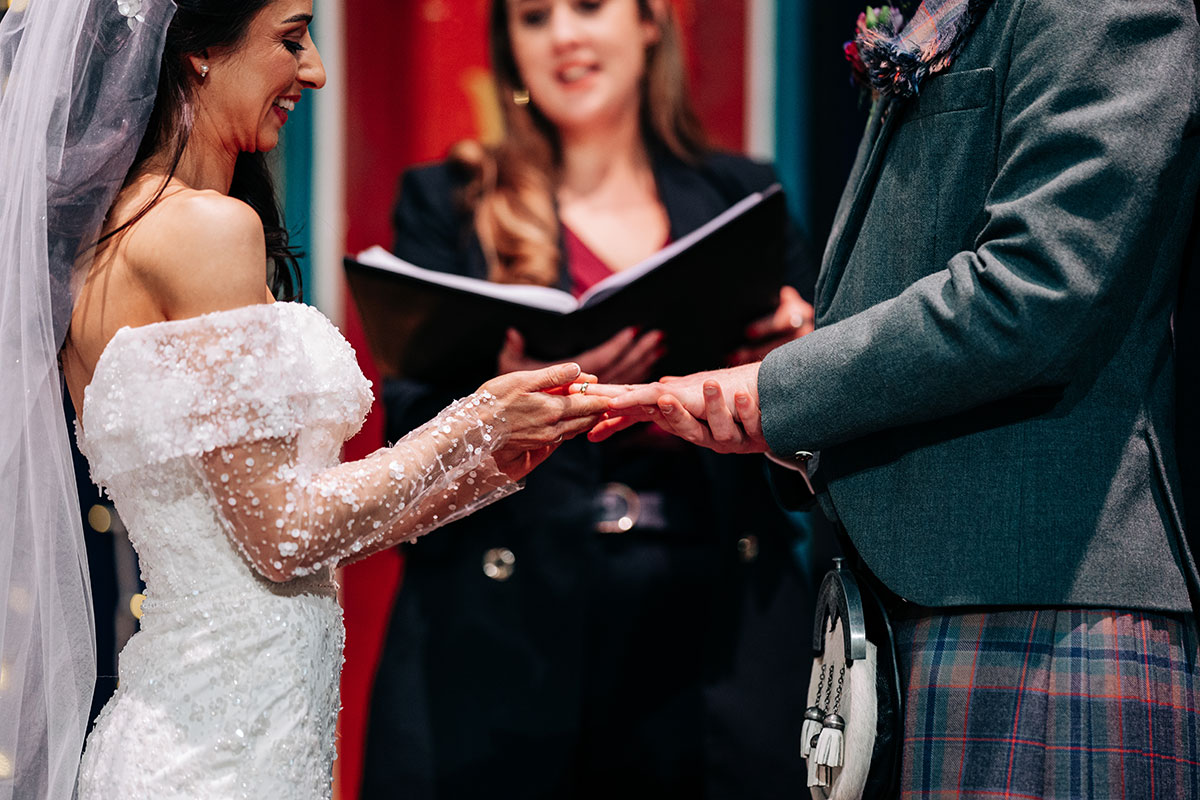 close up of bride and groom's hands as celebrant conducts a humanist ceremony at oran mor