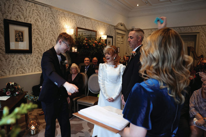 people standing up during a wedding ceremony 