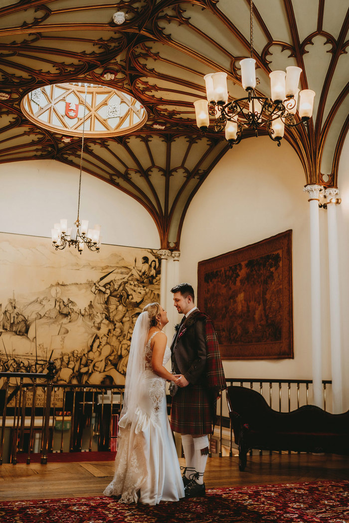 interior of dalhousie castle with bride and groom on wedding day