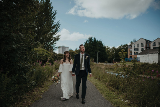 Couple walking hand in hand along a path