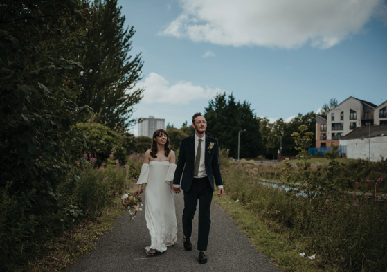 Couple walking hand in hand along a path