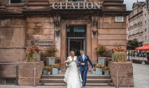 couple walking down steps of Citation wedding venue in Glasgow after getting married 