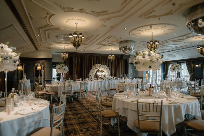 cornhill castle set up for a wedding dinner with white and blue floral centerpieces