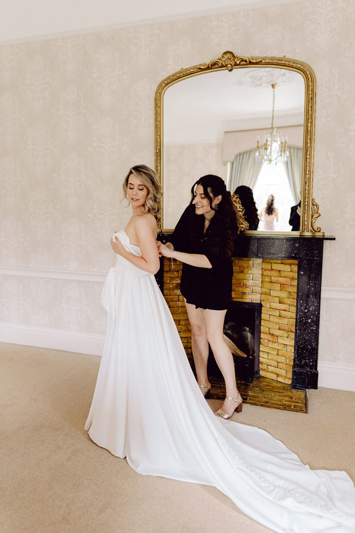 bride puts on wedding dress at drumtochty castle