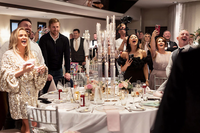 wedding guests cheering during a wedding at the Torrance Hotel