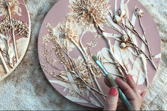 hand painting cast of flowers  in pink and white with paintbrush