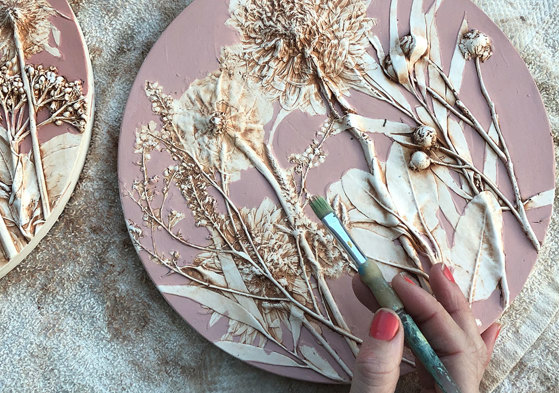 hand painting cast of flowers  in pink and white with paintbrush